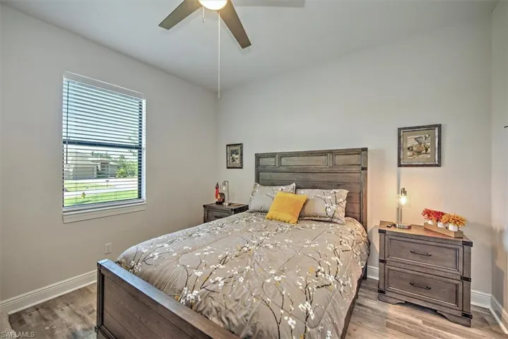 Bedroom with hardwood / wood-style flooring and ceiling fan