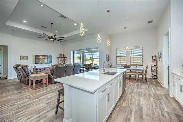 Kitchen featuring sink, light hardwood / wood-style floors, and white cabinetry