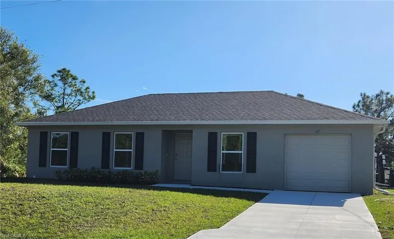 Single story home with a front yard, driveway, stucco siding, a garage, and a shingled roof