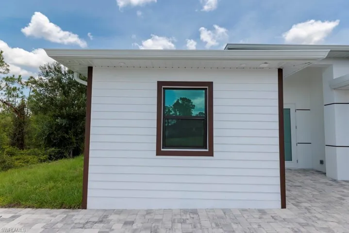 White horizontal siding exterior with contrasting dark trim