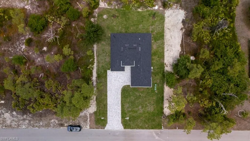 Single-story residence with a dark shingle roof and a light-colored paver driveway
