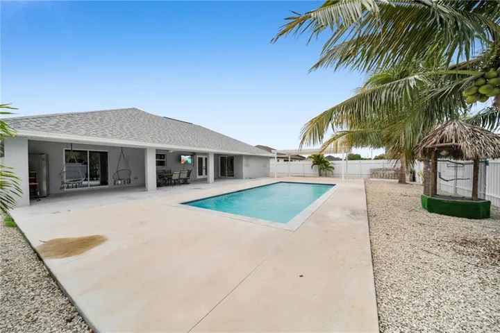 View of pool with a patio area and a fenced backyard
