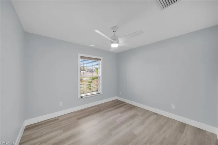 Unfurnished room featuring light wood-style flooring and ceiling fan