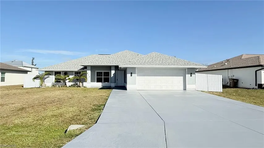 Single story home featuring roof with shingles, concrete driveway, stucco siding, and a garage