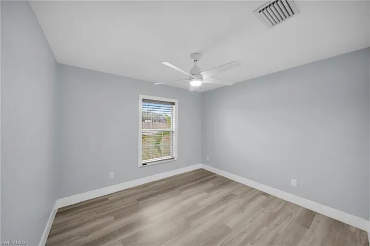 Spare room featuring light wood finished floors and ceiling fan