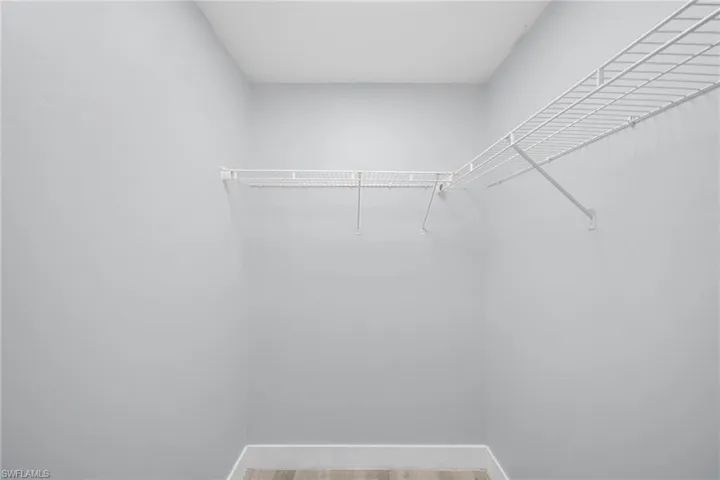 Walk in closet featuring light wood-style floors