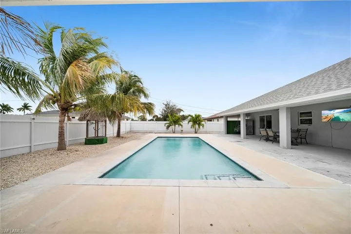 View of swimming pool featuring a patio area, a fenced backyard, and outdoor dining area