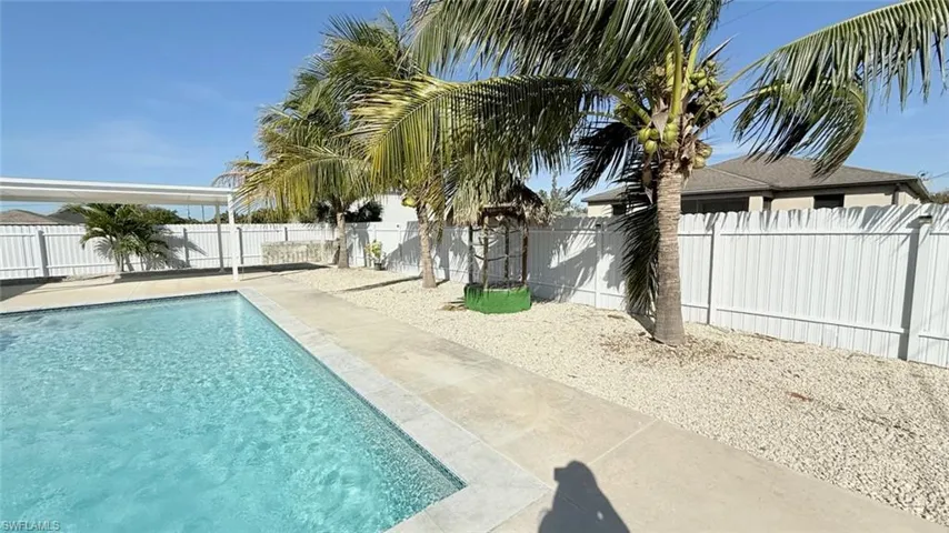 View of swimming pool with a fenced backyard