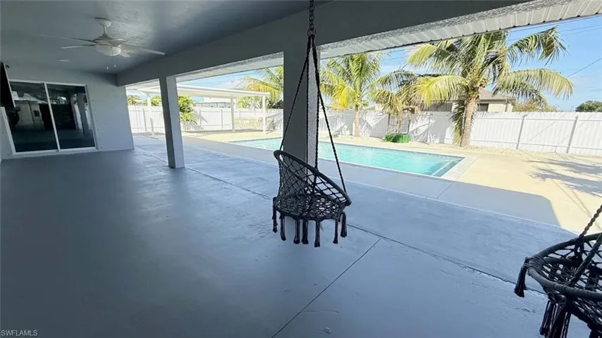 View of swimming pool with a patio and a fenced backyard