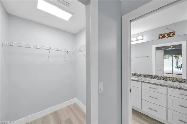 Walk in closet featuring light wood-style flooring