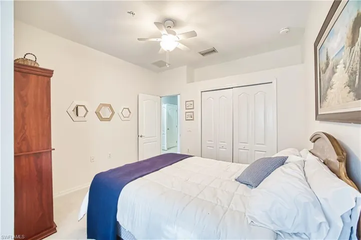 Comfortable room with a ceiling fan, white bi-fold closet doors, and recessed lighting