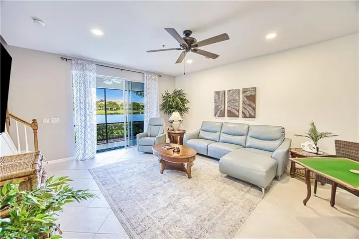 Spacious living area featuring tile flooring, recessed lighting, and a ceiling fan