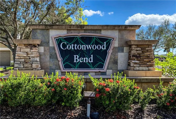 Community entrance sign featuring stacked stone columns and a textured stone facade