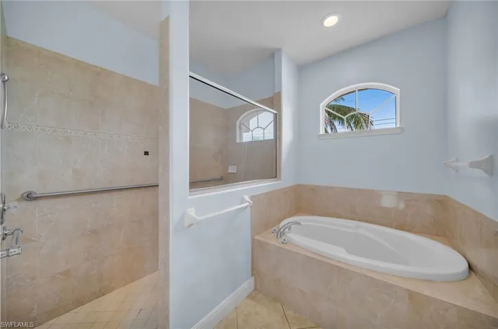 Full bathroom with walk in shower, a bath, and tile patterned flooring