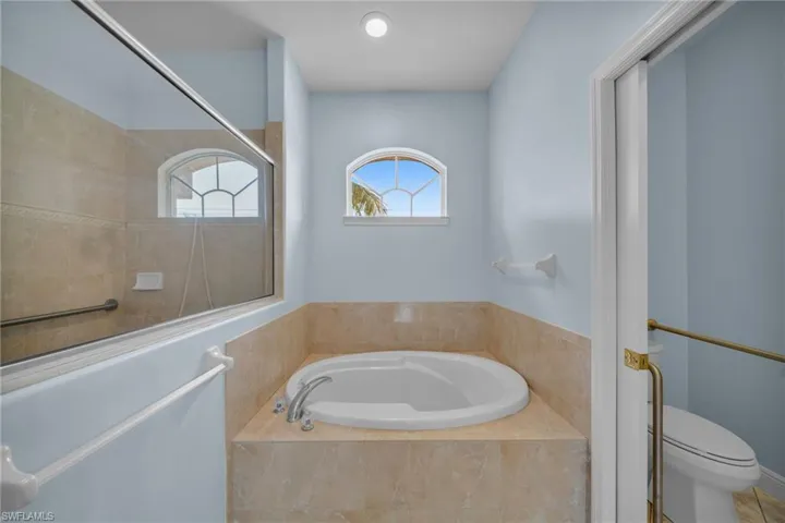 Bathroom with a garden tub and a tile shower