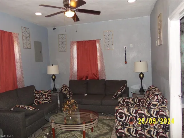 Tiled living room featuring ceiling fan