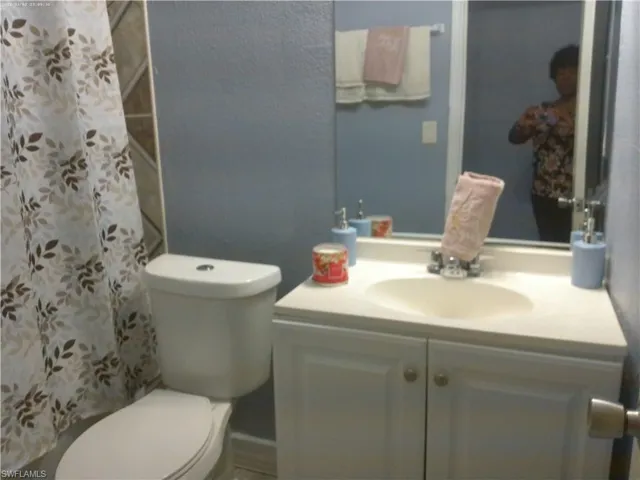 Bathroom featuring toilet and large vanity