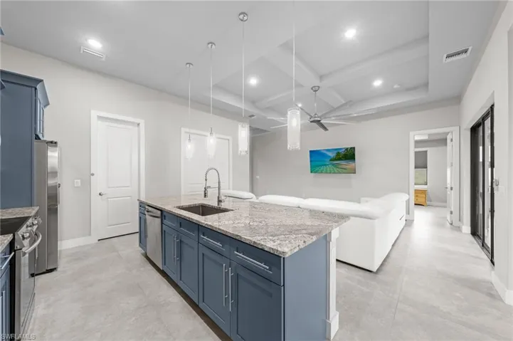 Bedroom with a tray ceiling, ceiling fan, and recessed lighting