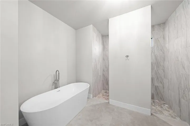 Tiled living area with a desk and ceiling fan