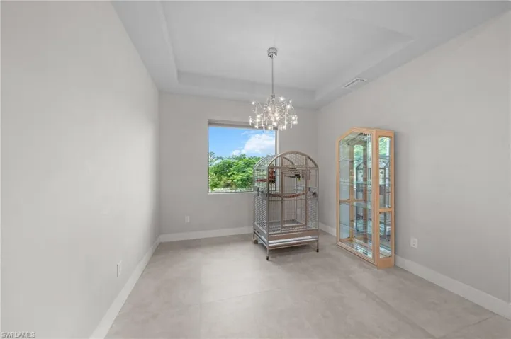 Bedroom with a raised ceiling, access to outside, a ceiling fan, recessed lighting, and light colored carpet