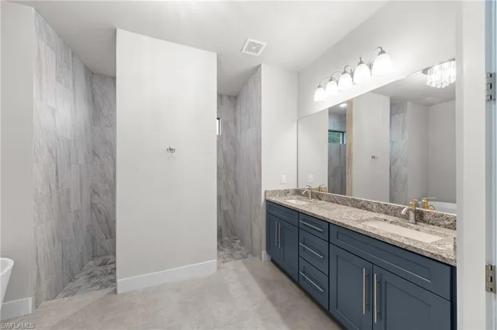 Bathroom with a sink and combined bath / shower with glass door