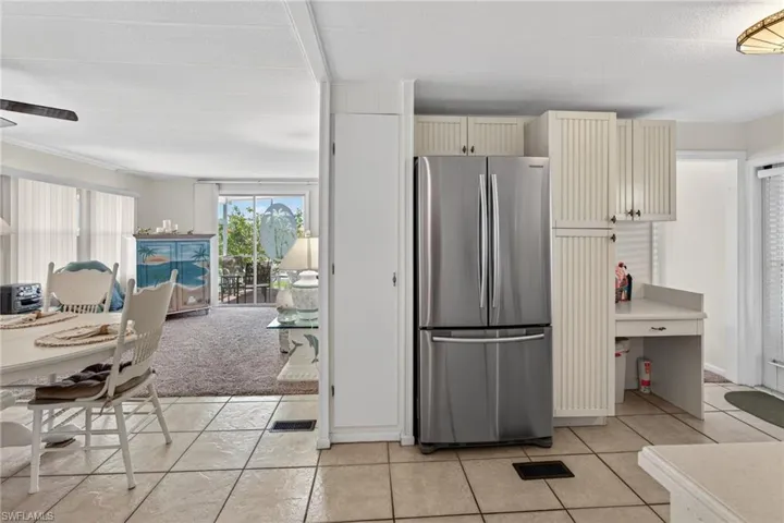 Kitchen with Pantry, refrigerator, cream cabinetry, light tile patterned floors