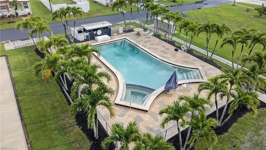 View of pool featuring a patio and a pool with connected hot tub