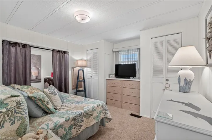 Bedroom with carpet floors and a textured ceiling