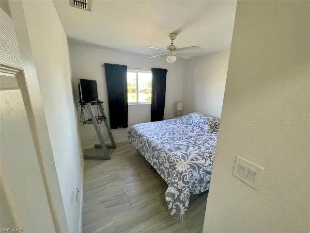 Bedroom with visible vents, baseboards, and ceiling fan