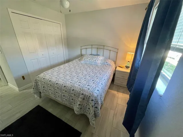 Bedroom featuring baseboards, a closet, and light wood-type flooring