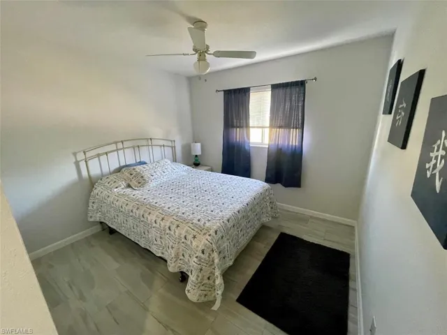 Bedroom with baseboards and a ceiling fan