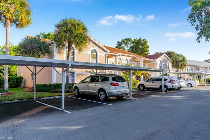 Covered parking lot featuring a residential view