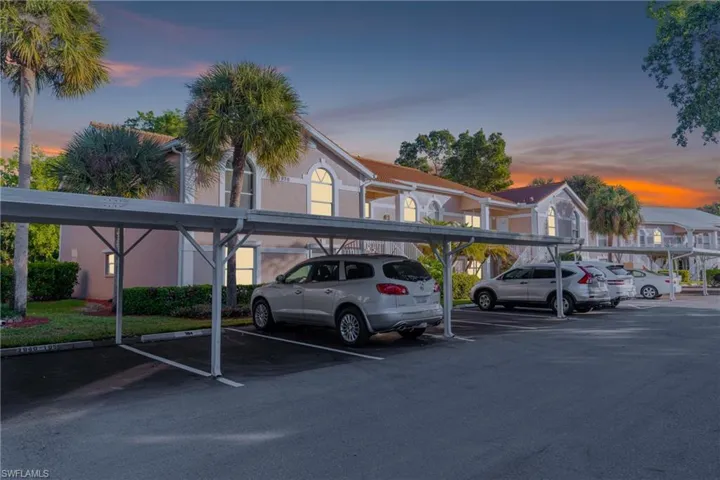 Parking at dusk featuring covered parking