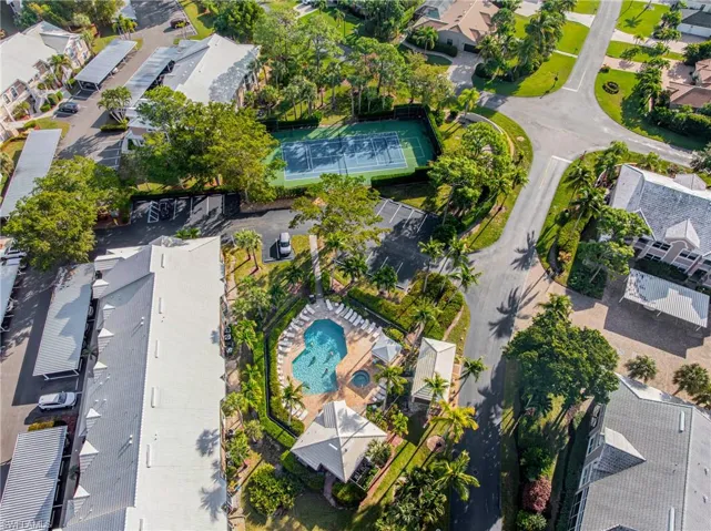 Aerial view of property and surrounding area featuring nearby suburban area