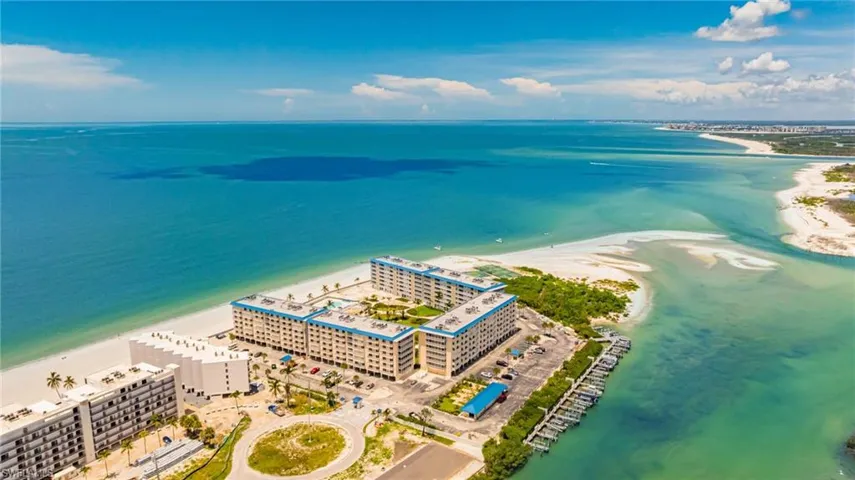 Bird's eye view of expansive coastline and apartment complex