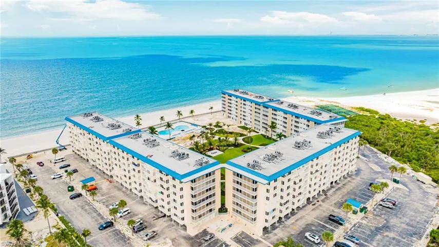 Aerial view of expansive coastline and apartment complex / building