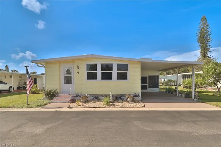 Single-story residence with a light yellow exterior and multiple windows