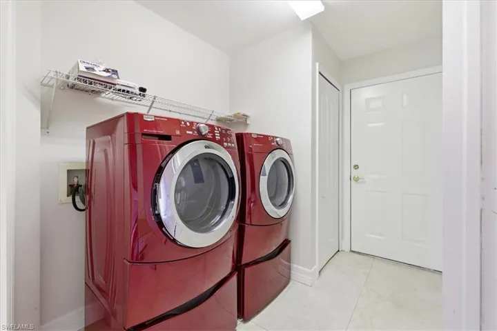 Laundry area featuring tile flooring and a built-in wire shelf