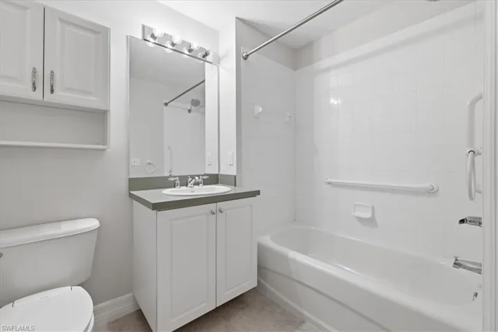 Bathroom featuring a white vanity with an undermount sink, a gray countertop, and overhead lighting