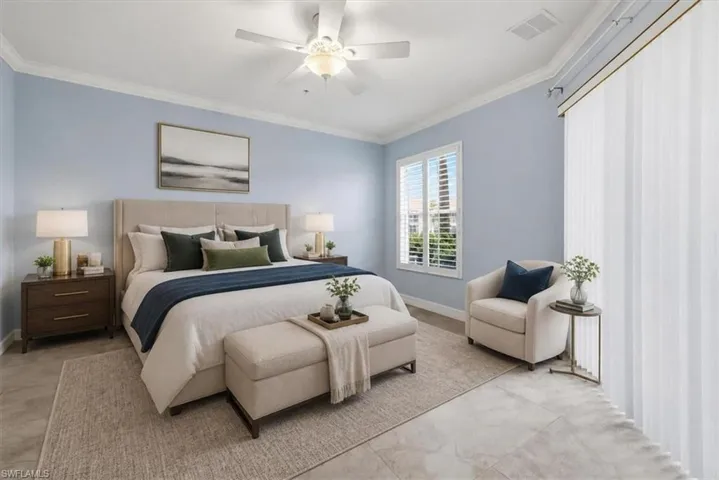 Virtually staged. Spacious room featuring light blue walls, crown molding, a ceiling fan with integrated lighting, plantation shutters, and large format tile flooring
