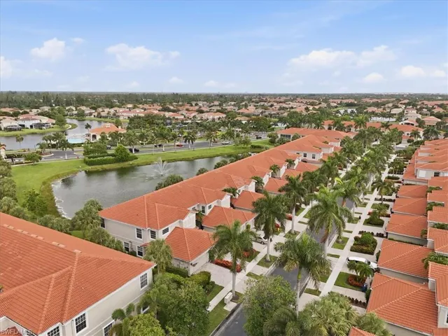 Community landscape featuring numerous residential properties with terracotta-style roofs