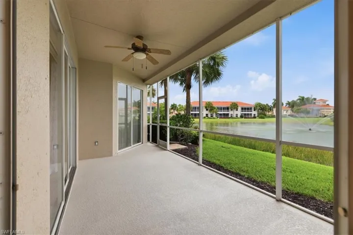 Screened lanai featuring a ceiling fan, sliding glass doors, and textured flooring