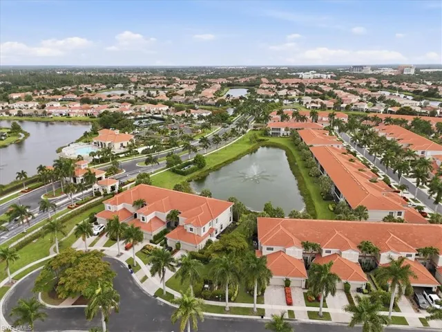 Aerial perspective showcasing a residential community with abundant green spaces and water features