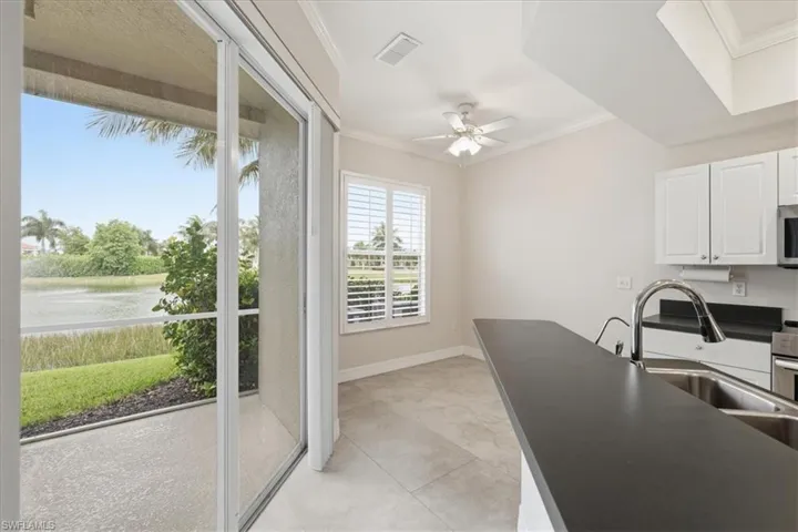 Kitchen featuring white cabinetry, stainless steel appliances, and a double basin sink