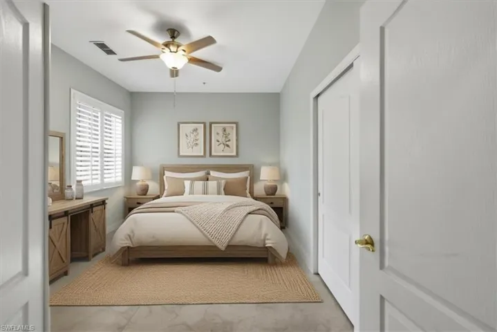 Light-filled room featuring a ceiling fan with integrated lighting, a window with plantation shutters, a full-height closet with sliding panel doors, and tile flooring