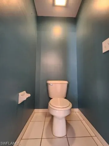 Bathroom with toilet and tile patterned floors