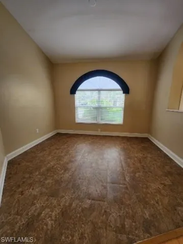 Unfurnished room with baseboards