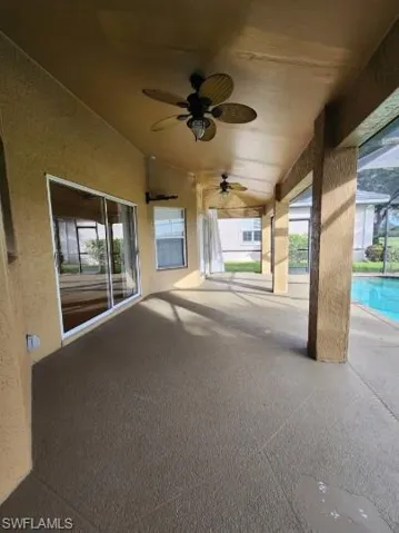 View of patio / terrace featuring ceiling fan, an outdoor pool, and a lanai