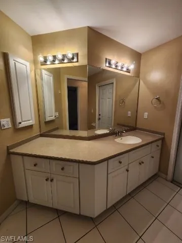 Bathroom featuring vanity and light tile patterned floors