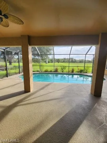 Swimming pool with a sunroom, a patio, and a lanai